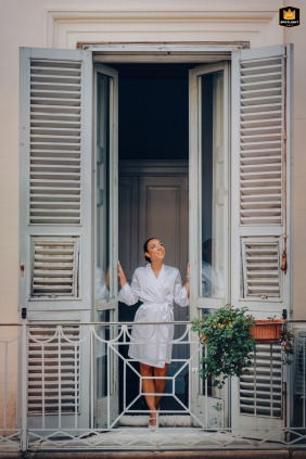 A bride, seen from a window at Palazzo Cavali B&B in Lucera, prepares for her wedding. The shot shows her before she puts on her dress in the ancient palace.